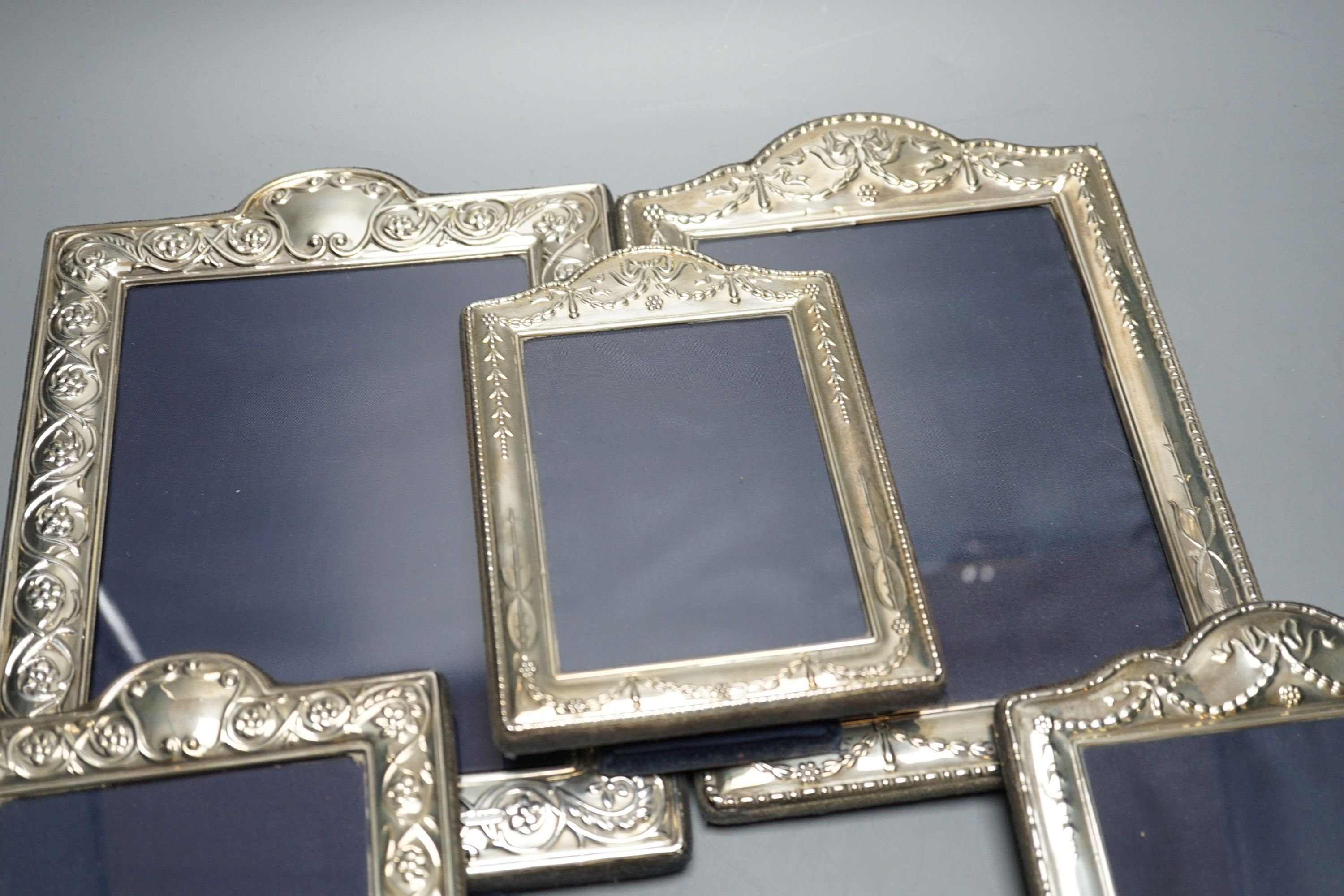 Two modern graduated pairs of decorated silver mounted photograph frames, Carrs of Sheffield, 2000 & 2001, largest 25.6cm and two smaller silver mounted frames.